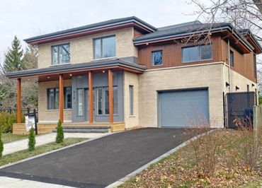 Modern two-story house with a spacious driveway and garage.