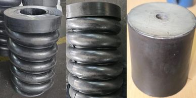 Three metal coil springs and a cylindrical metal piece.