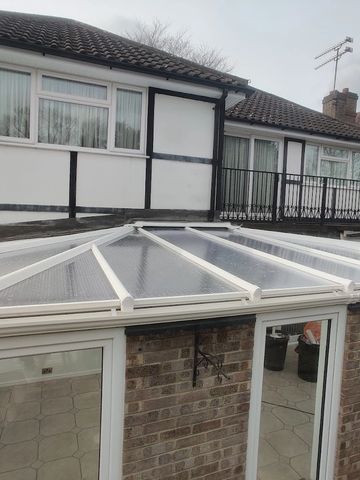 a brick conservatory with uPVC double glazed windows and a polycarbonate conservatory roof