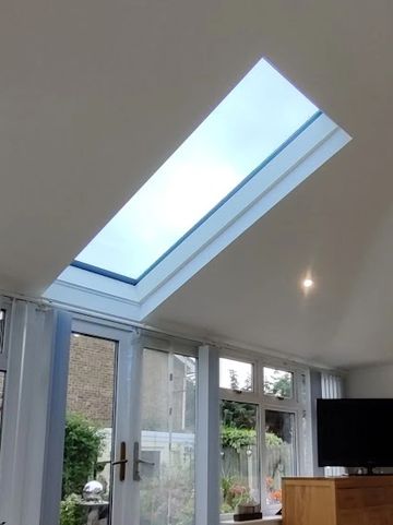 the inside of a plastered and insulated SupaLite tiled conservatory roof with a velux window