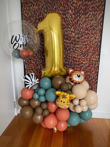 Freestanding balloon arrangement with foil number and custom decal.
