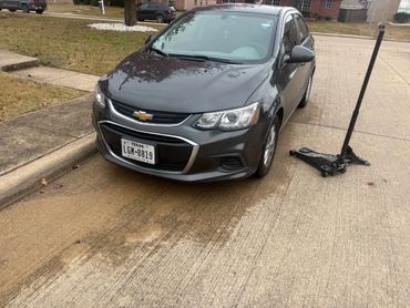 Black Chevrolet parked on a street after repair