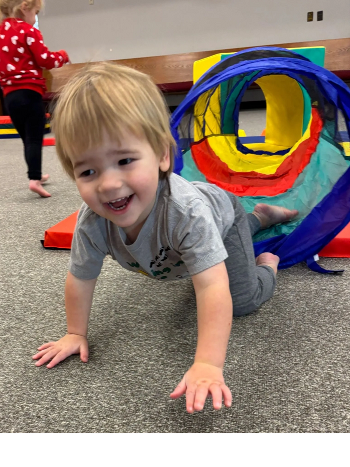 Boy crawling through tunnel
