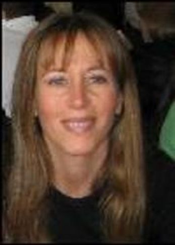 Joyful woman with a bright smile looking directly ahead