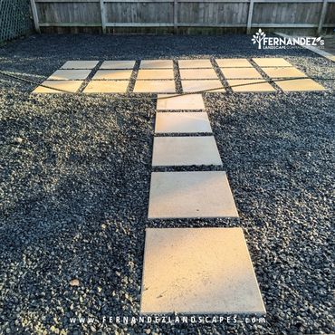 Concrete stepping pavers set in black gravel