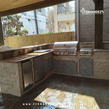 Outdoor kitchen with a built-in grill and stone counter
