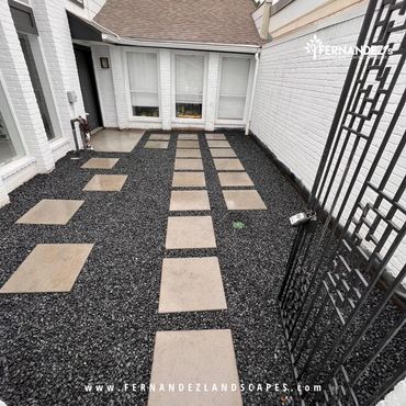 Concrete squares set in black gravel in a courtyard