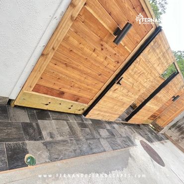Horizontal cedar gate and fence above a paver walkway