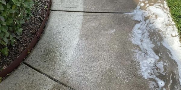 Concrete sidewalk being cleaned with soap and water.