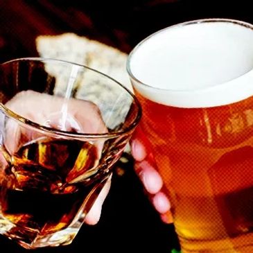 Glass of Whiskey and Pint of beer clinking togeather