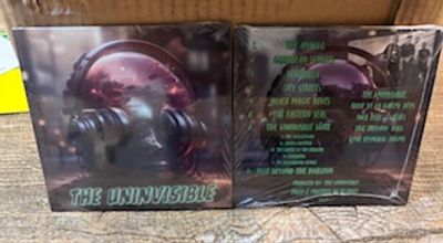 CD album titled 'The Uninvisible' with a futuristic helmet on the cover.