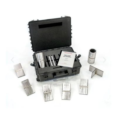A black case with metal tools and accessories arranged around it.