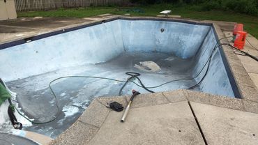 Before sandblasting paint from concrete pool in New Jersey