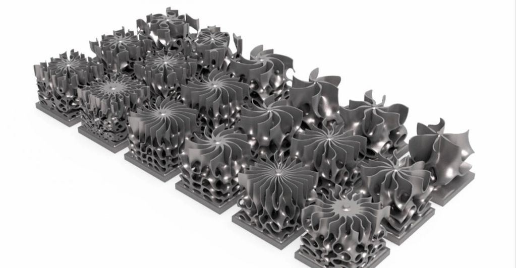 Metallic 3D printed lattice structures arranged in rows.