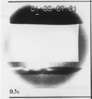 Black and white image showing a time-lapse of a bright explosion or light burst.