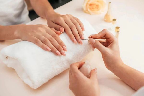 Manicure session with delicate nail care.