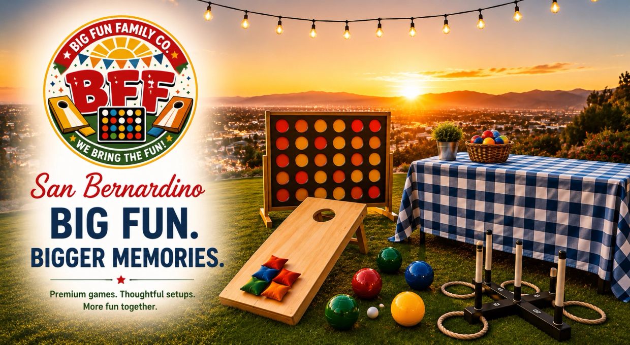 Outdoor lawn games setup at sunset with a city view and festive lights.