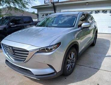 Fully detailed grey SUV with wax coating