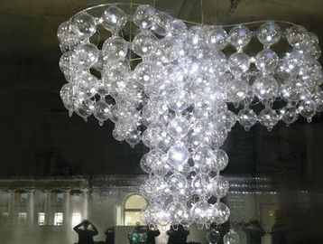 A large chandelier made of numerous clear glass spheres.