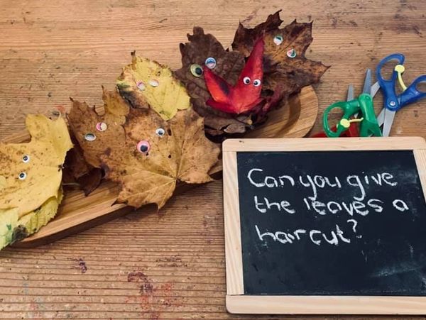 Using fine motor skills to cut up leaves