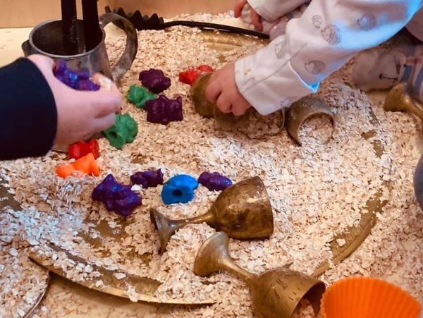 Using cups for sensory play with other children