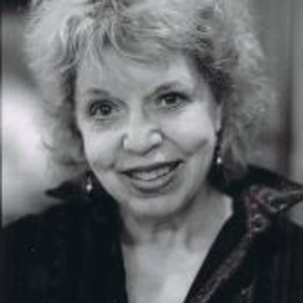 Black and white portrait of a smiling woman.