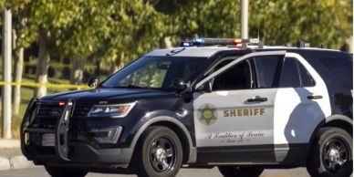 Sheriff's SUV parked with door open.