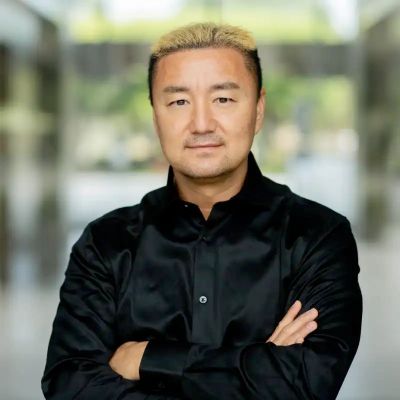 Man with folded arms wearing a black shirt.