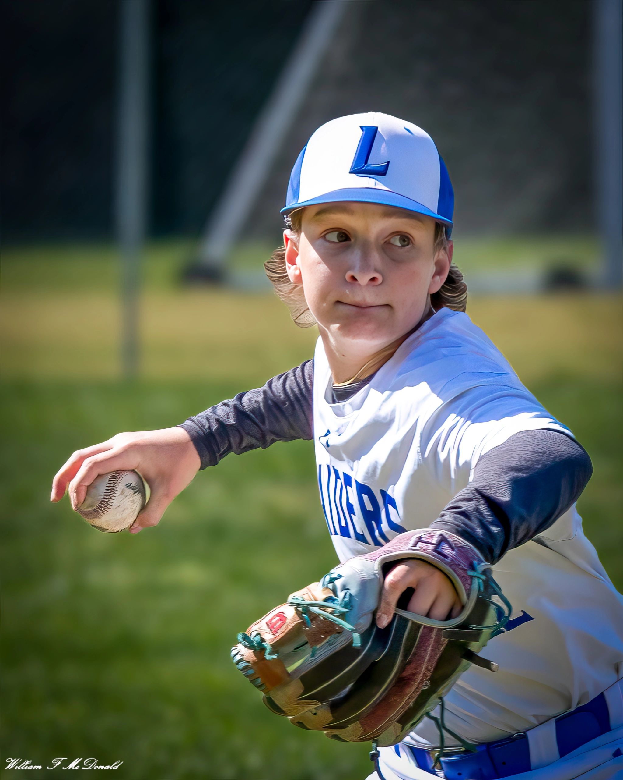 Young baseball pitcher in action, focused and ready to throw.