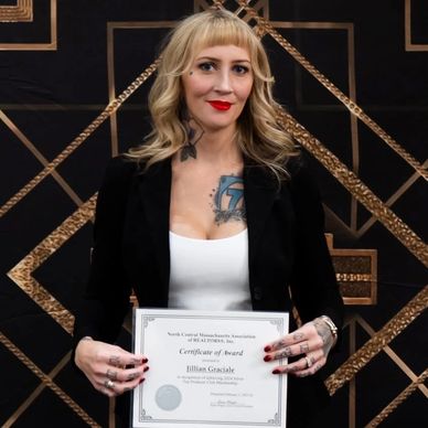 Woman holding a certificate of award.