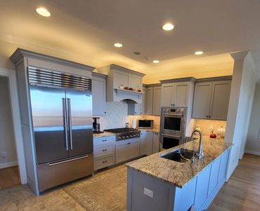 Modern kitchen with recessed lighting and under-cabinet LED fixtures installed