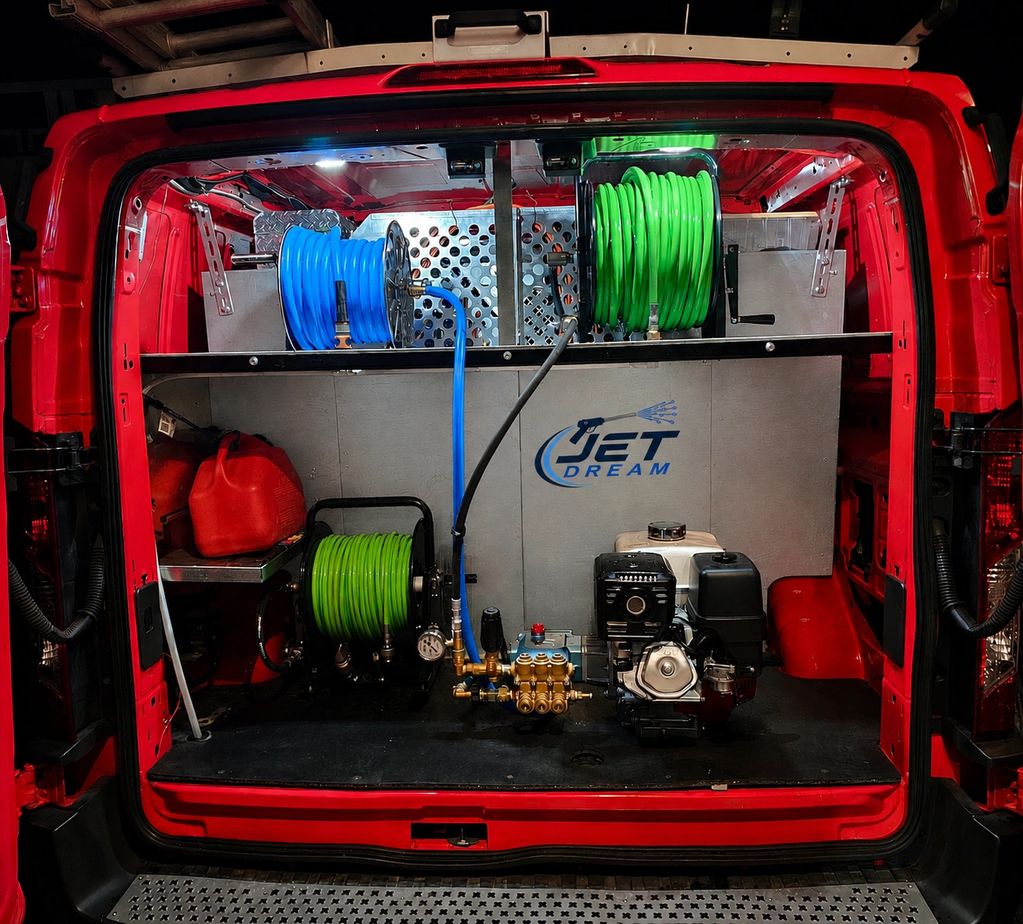 Organized equipment setup inside a red utility van.