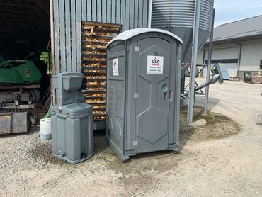 Portable toilet on a farm with portable handwash sink in Sugarcreek, Ohio