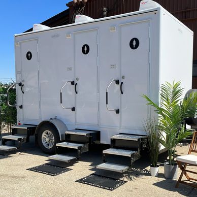 Fancy white restroom trailer for weddings and events.