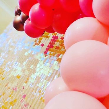 Pink sequin wall with pink balloons