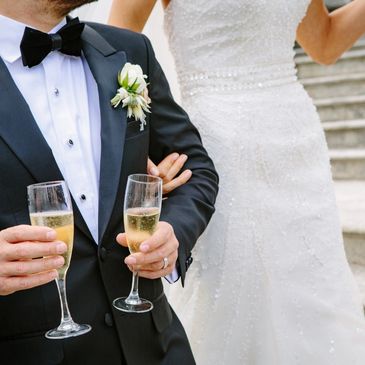 Couple celebrating with a glass of fizz at a simply prosecco wedding in lincolnshire