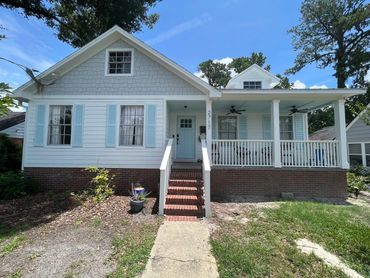 Home with white Hardie lap siding, light blue shutters, and light gray Hardie shakes on front gable