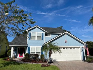 Atlantic Beach home with Hardie panel siding and Hardie shake siding painted light blue