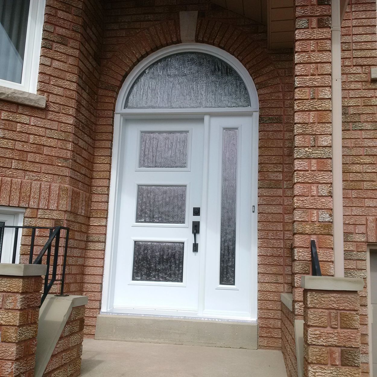 White Elm Entry Doors with window inserts and side light. Front door hardware.