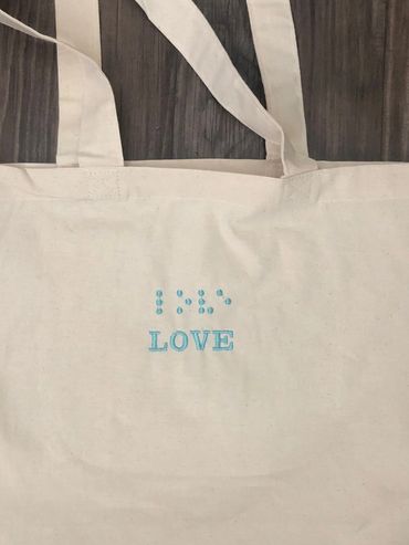 Canvas bag with turquoise thread. Love in print and Braille
