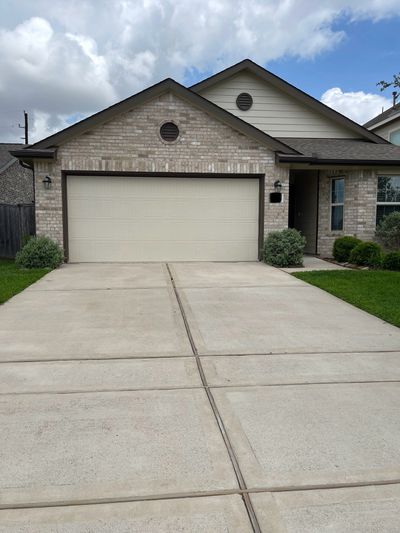 Pressure-washed home with great looking driveway.