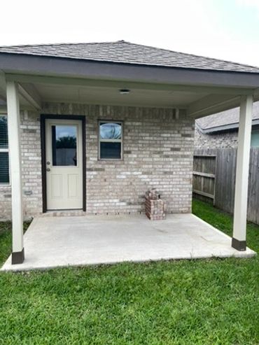 Finished pressure washing of a back patio on a home.