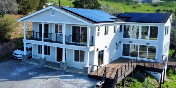 Modern white house with solar panels on the roof.
