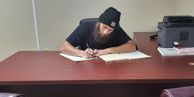 Owner of No Collateral Bail Bonds Florida doing paperwork at 349 W Alfred st Tavares fl 32778