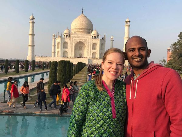 Photo of man and woman in front of the Taj Mahal