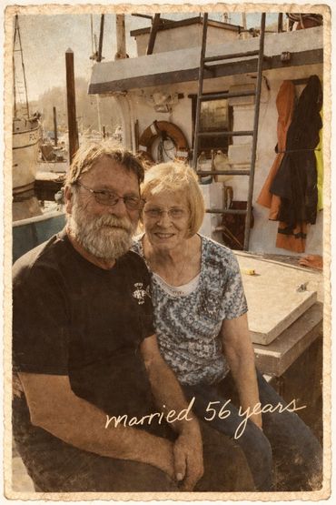 Elderly couple smiling, celebrating 56 years of marriage on a boat.