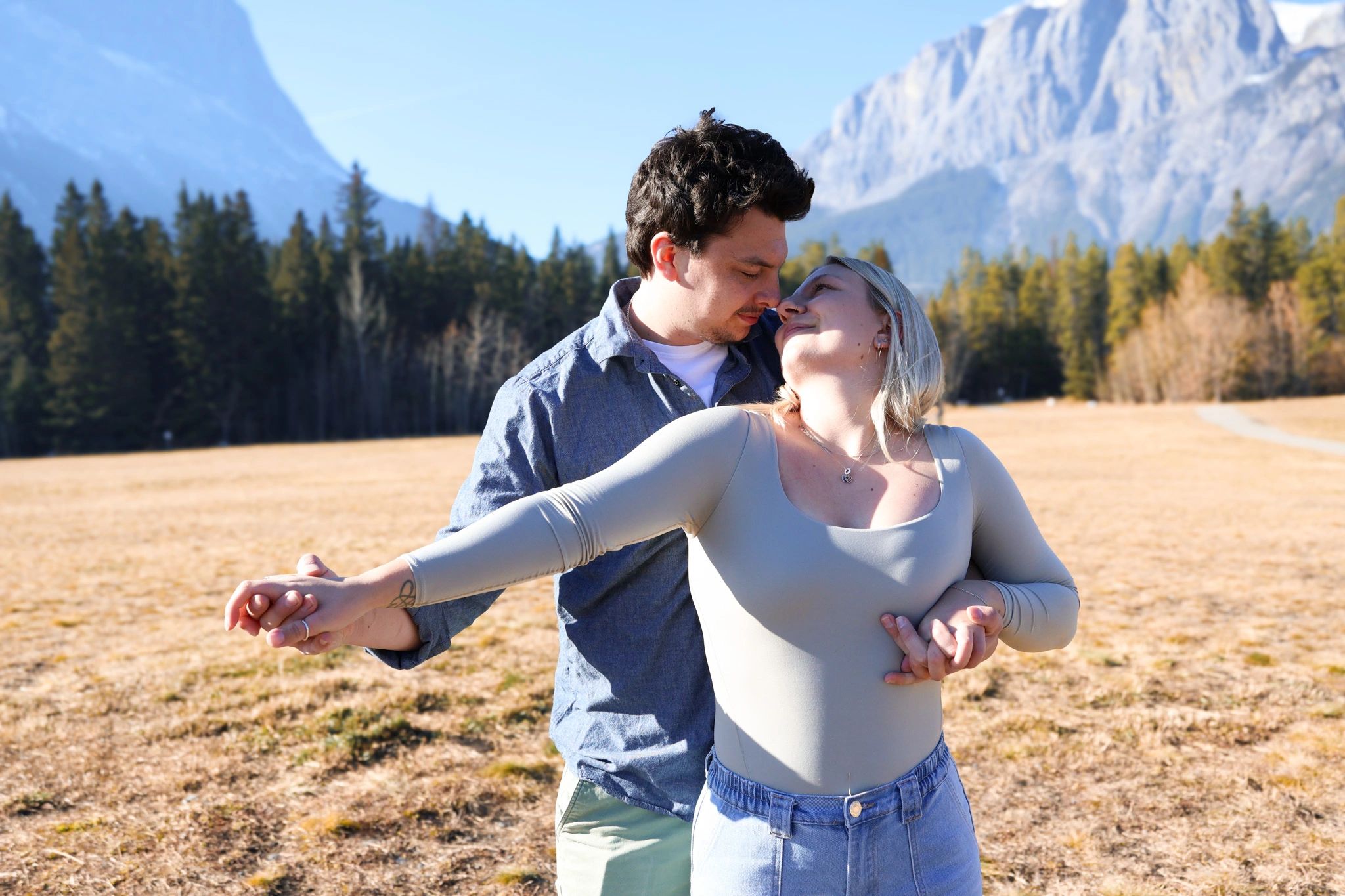 Couple staring at one another with a Rocky Mountain backdrop