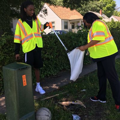 Directors assisting with cleaning up a Portsmouth neighborhood.