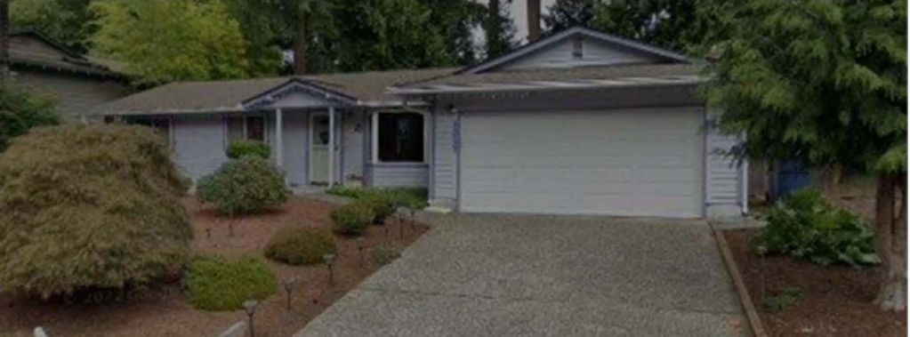 Exterior photo of unrenovated reverse floor plan home similar to the home shared with Jeanette.