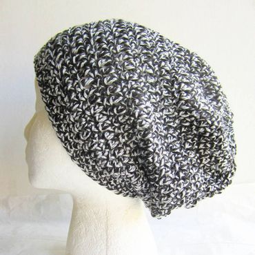 Black and white crocheted slouchy beanie on a mannequin head.